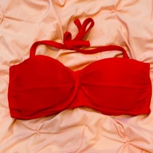 Strapless red swimsuit top with attachable strap.